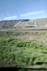 Train passenger documents countryside railway journey through moving window