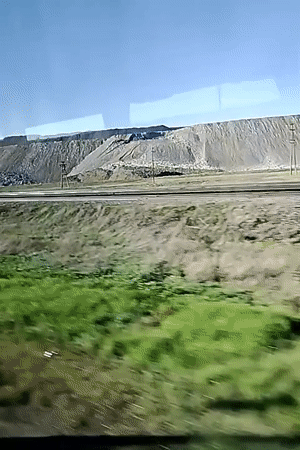 Train passenger documents countryside railway journey through moving window