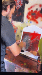 Man and woman spray-paint white T-shirt together