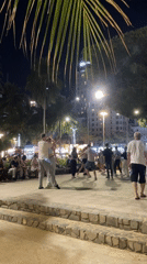 Couples dance outdoors in Nha Trang plaza at night
