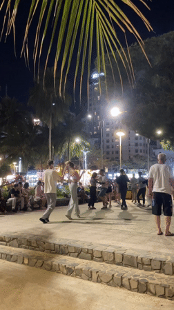 Couples dance outdoors in Nha Trang plaza at night