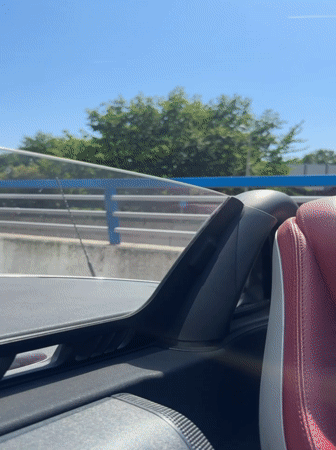 Convertible drives through The Hague city center on sunny afternoon