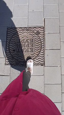 Woman in pink outfit photographed walking through Yekaterinburg streets