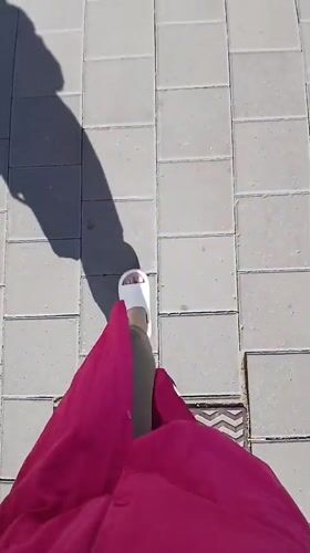 Woman in pink outfit photographed walking through Yekaterinburg streets