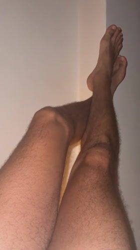 Person rests with feet up against wall in Thailand