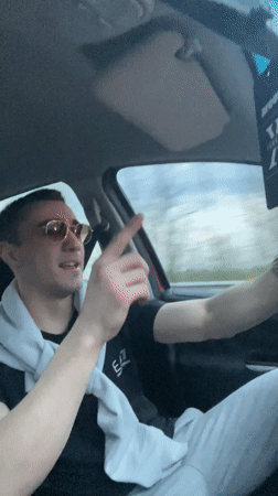 Young men drive through Bulgarian village, driver singing