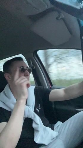 Young men drive through Bulgarian village, driver singing