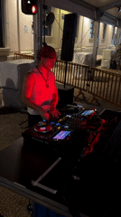 Pioneer decks, red lighting, and a live DJ set in Milan