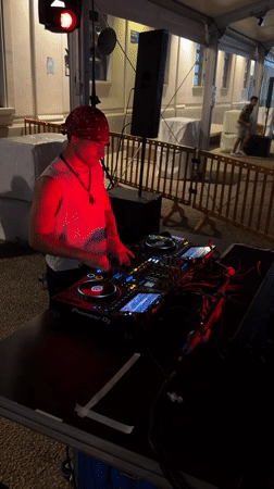 Pioneer decks, red lighting, and a live DJ set in Milan