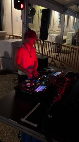 Pioneer decks, red lighting, and a live DJ set in Milan