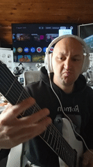 Musician plays eight-string guitar in Portugal session