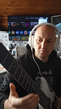 Musician plays eight-string guitar in Portugal session