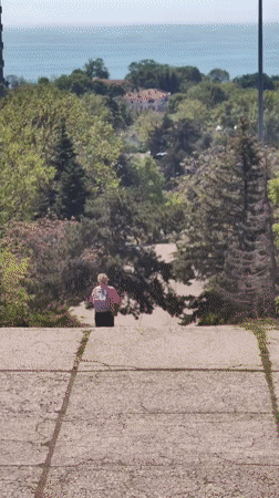 Shirtless man performs parkour near coastal area, caught on video
