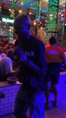 Solo dancer performs in neon-lit Obosi bar