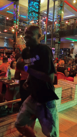 Solo dancer performs in neon-lit Obosi bar