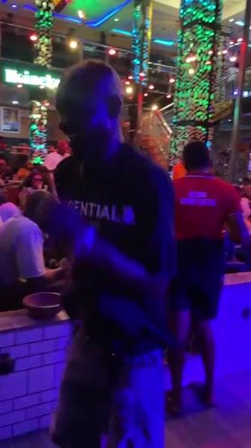 Solo dancer performs in neon-lit Obosi bar