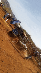 Off-road vehicle navigates muddy course before crowd