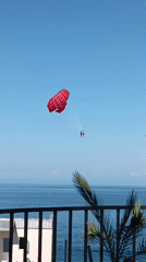 Kobuleti beach buzzes with swimmers, inflatables, and parasailing