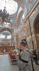 Cameraman documents ornate Orthodox church interior architecture