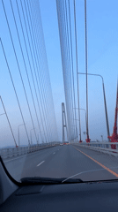 Vehicle crosses cable-stayed bridge in Vladivostok during dawn hours