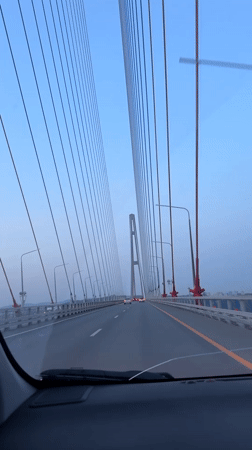 Vehicle crosses cable-stayed bridge in Vladivostok during dawn hours