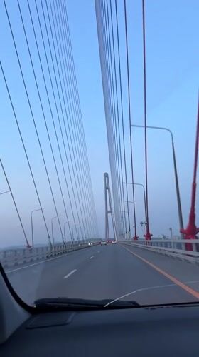 Vehicle crosses cable-stayed bridge in Vladivostok during dawn hours