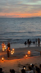 Fire dancing performance on Ban Ao Nang beach at sunset
