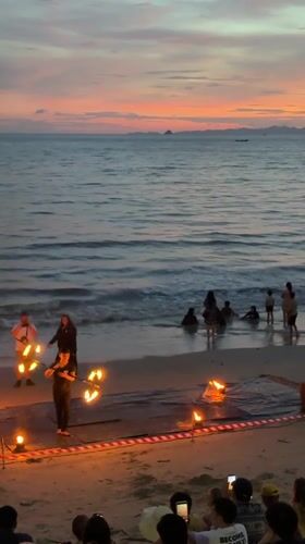 Fire dancing performance on Ban Ao Nang beach at sunset