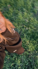 Young women spend afternoon in grassy field in Zhigalki