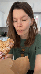 Woman enjoys almond croissant breakfast in Limassol, Cyprus