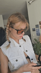 Woman takes selfies in white outfit in Pantin apartment