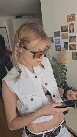 Woman takes selfies in white outfit in Pantin apartment