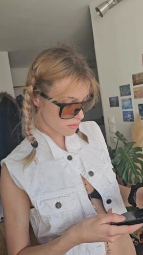 Woman takes selfies in white outfit in Pantin apartment