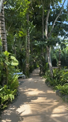 Woman walks through tropical resort pathways in Blahbatuh, Indonesia