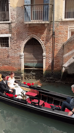 Wedding couple and tourists crowd Venice canals and streets