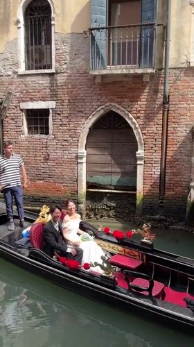 Wedding couple and tourists crowd Venice canals and streets