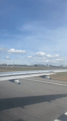 Passenger films wing view during aircraft movement in Thailand