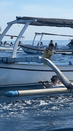 Outrigger boats carry passengers in calm waters near Seririt