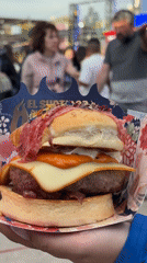 Turquoise burger served at outdoor food event in Barcelona