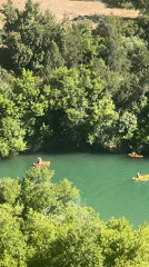 Kayakers enjoy afternoon paddle on green river in Morocco