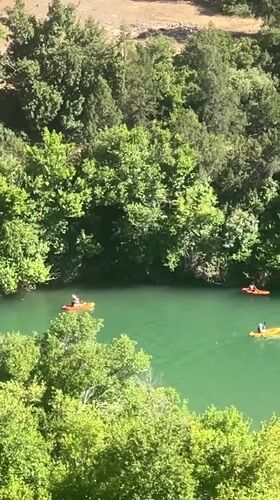 Kayakers enjoy afternoon paddle on green river in Morocco