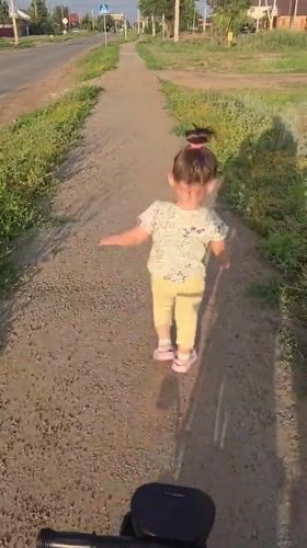 Chalk sun and a stroller walk along a dirt path in Oral