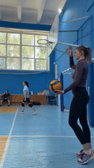 Woman practices volleyball at Tyumen gymnasium early morning