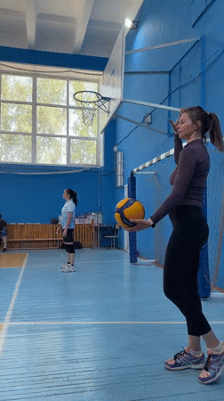 Woman practices volleyball at Tyumen gymnasium early morning