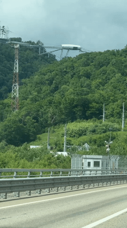 White structure spotted atop forested hill in Adlerskiy, Russia