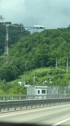 White structure spotted atop forested hill in Adlerskiy, Russia