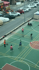 Four players enjoy late night badminton in Baiyun District