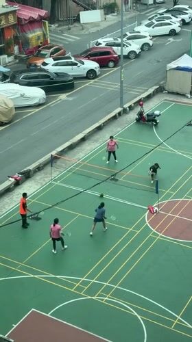 Four players enjoy late night badminton in Baiyun District