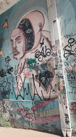 São Paulo street scene: murals, motorcycles, and blooming trees