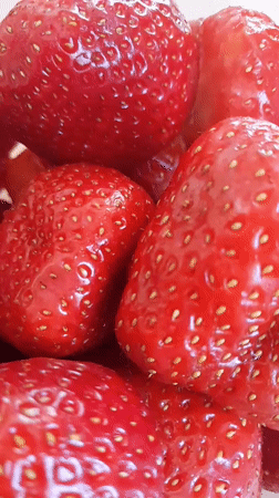 Close-up look at a pile of fresh ripe strawberries